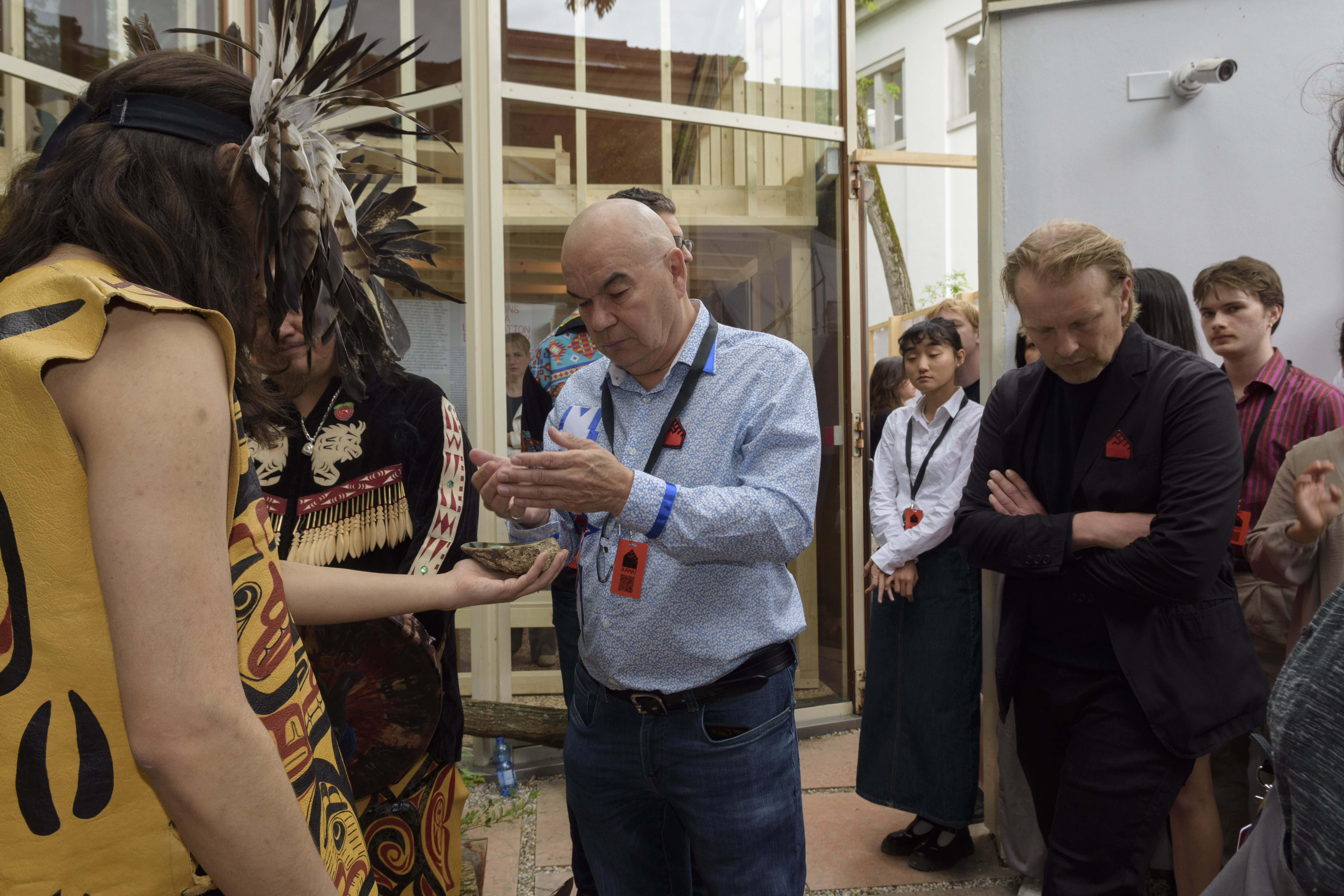 Image of two people engaging in a smudging ceremony in the pavilion courtyard.