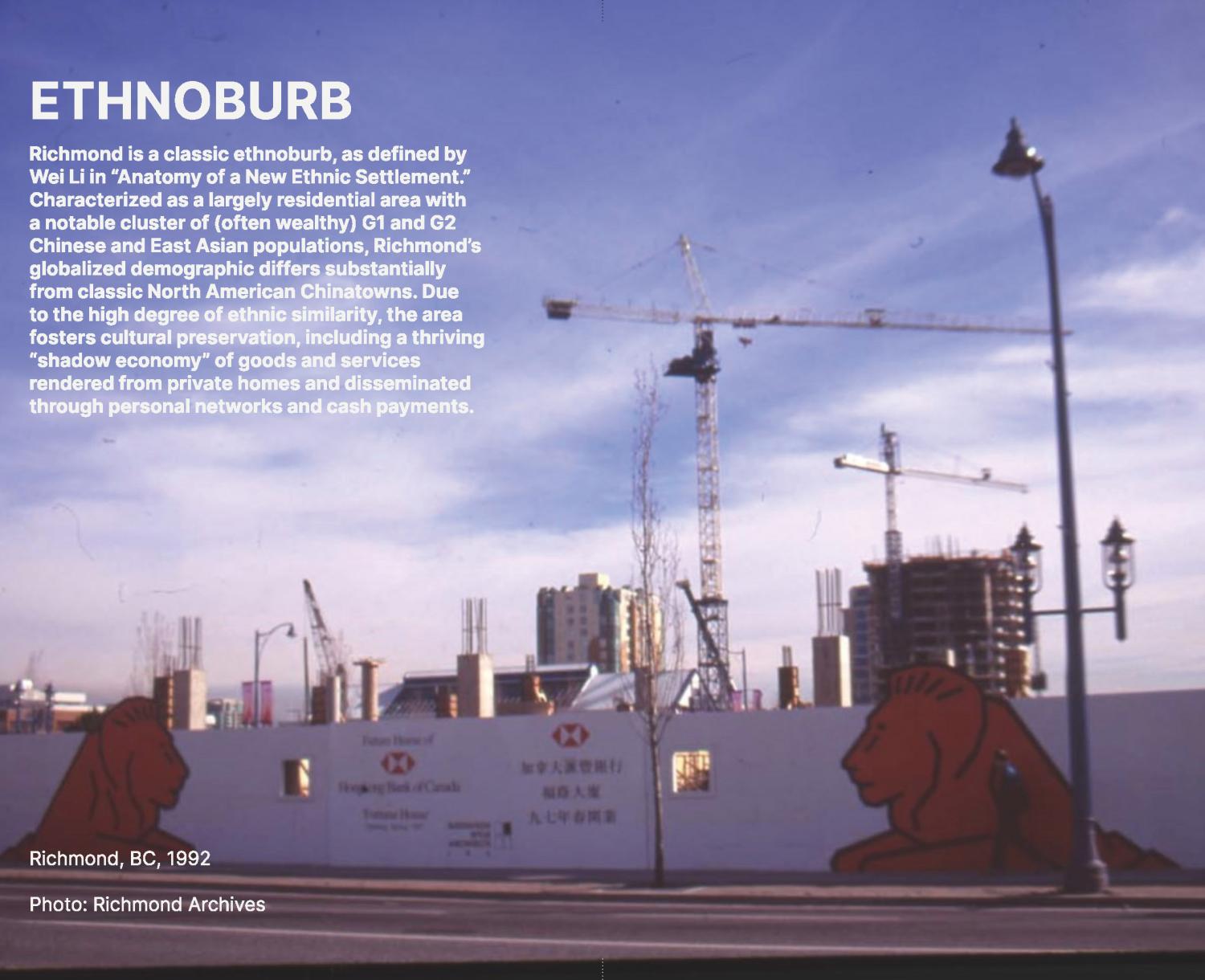 Photograph of construction site with two cranes and white hoarding decorated with advertisement for HSBC bank.