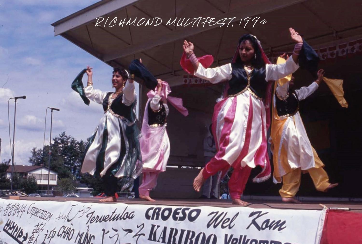 Image of four people dancing on a stage wearing traditional clothing.