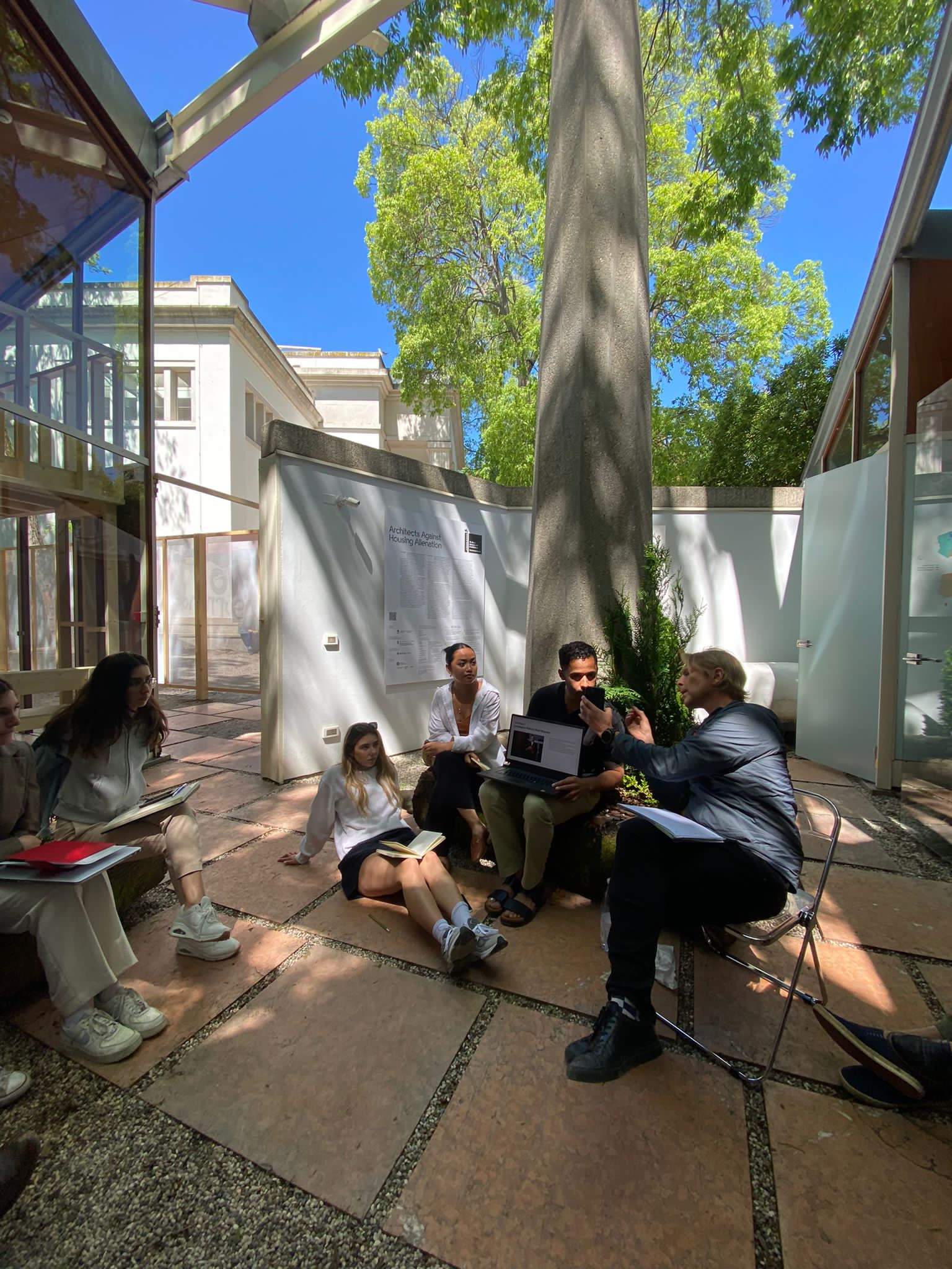 Image of students gathered and conversing around a computer.